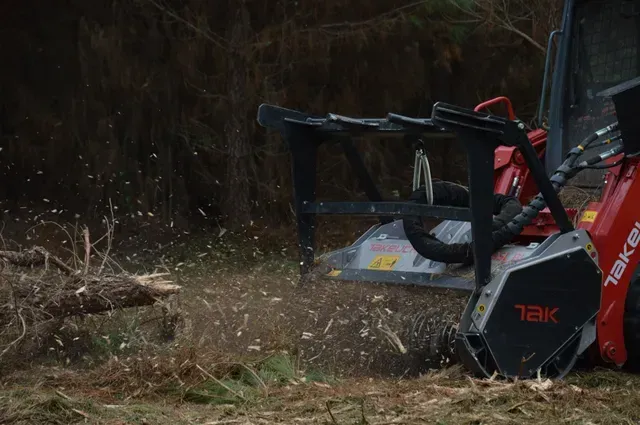 FAE mulcher head close-up with wood chips flying