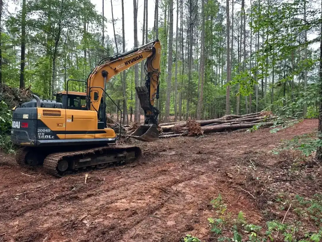 Hyundai excavator staged on a land clearing project
