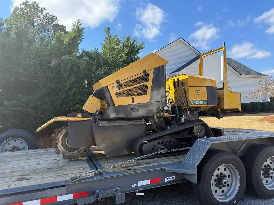 Vermeer SC48TX stump grinder processing stump on residential property